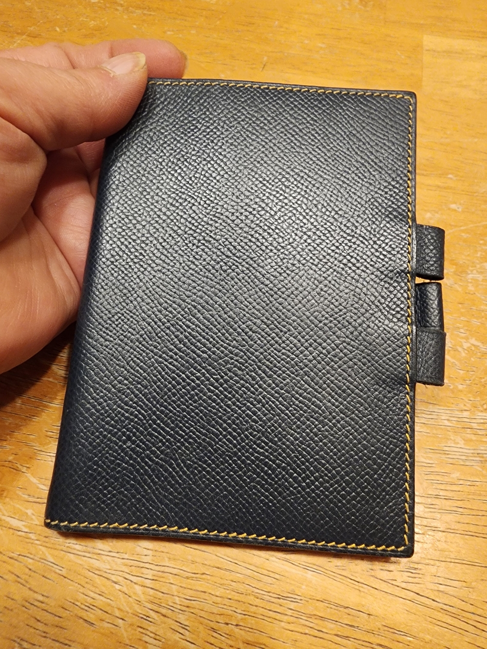 blue Hermès agenda cover featuring textured leather and prominent yellow contras